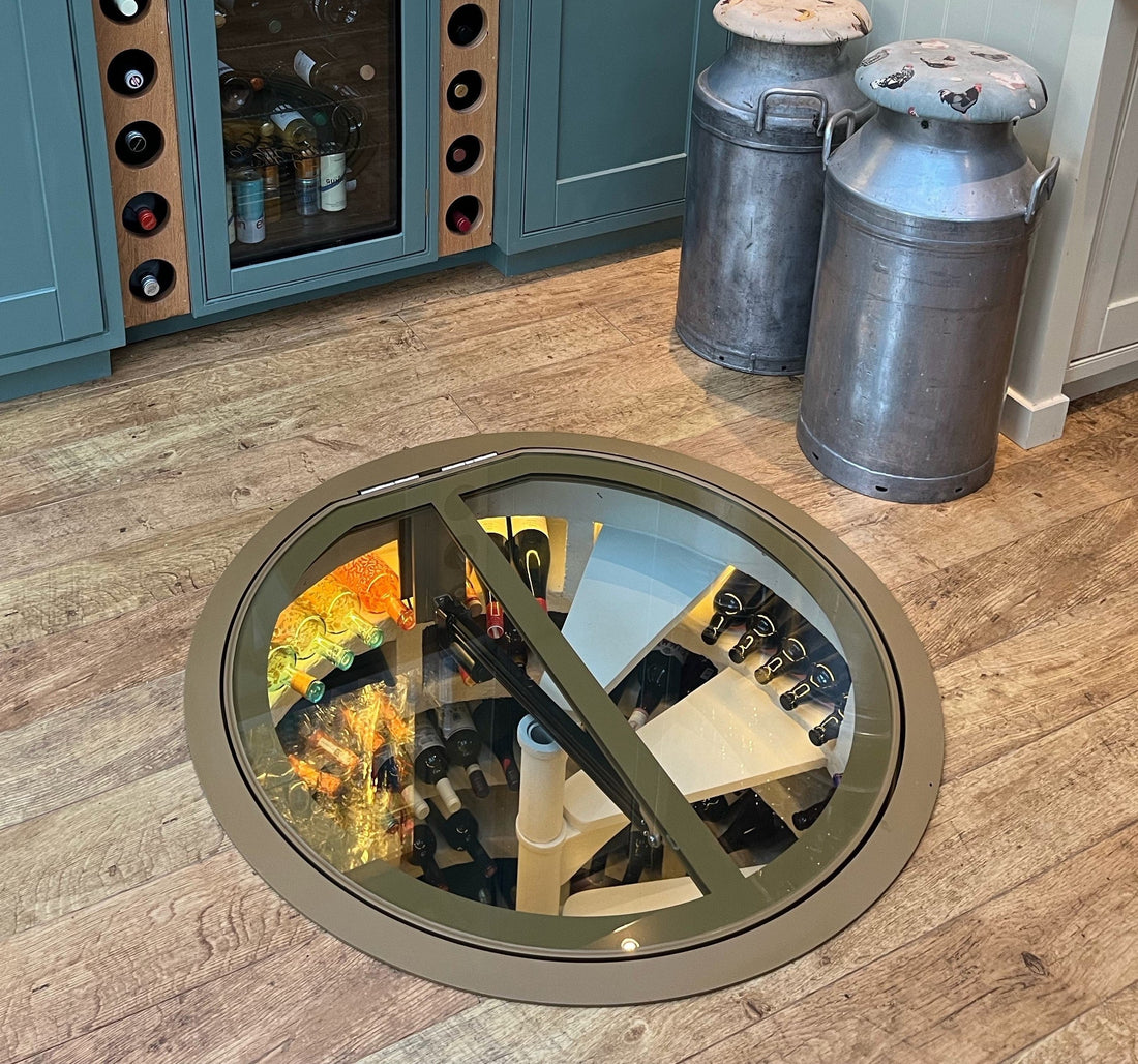 electric wine cellar glass door over spiral staircase in kitchen