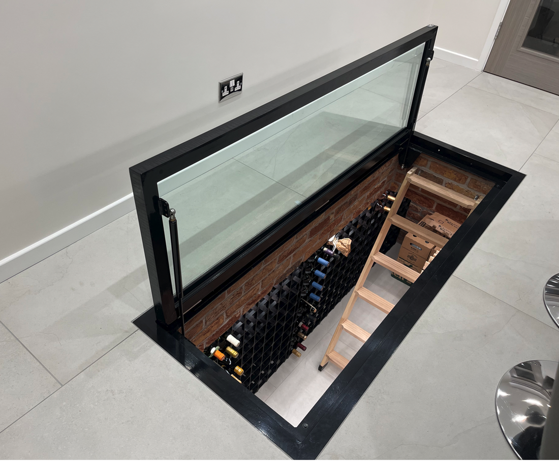 wine cellar glass door access hatch in modern kitchen