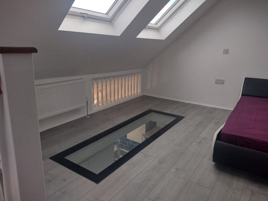 glass floor in attic room giving more light to main house