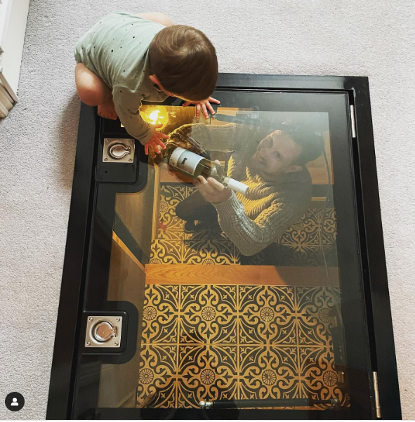 Hinged glass wine cellar door by Glass Floor Systems Ltd with invisible non-slip treatment.