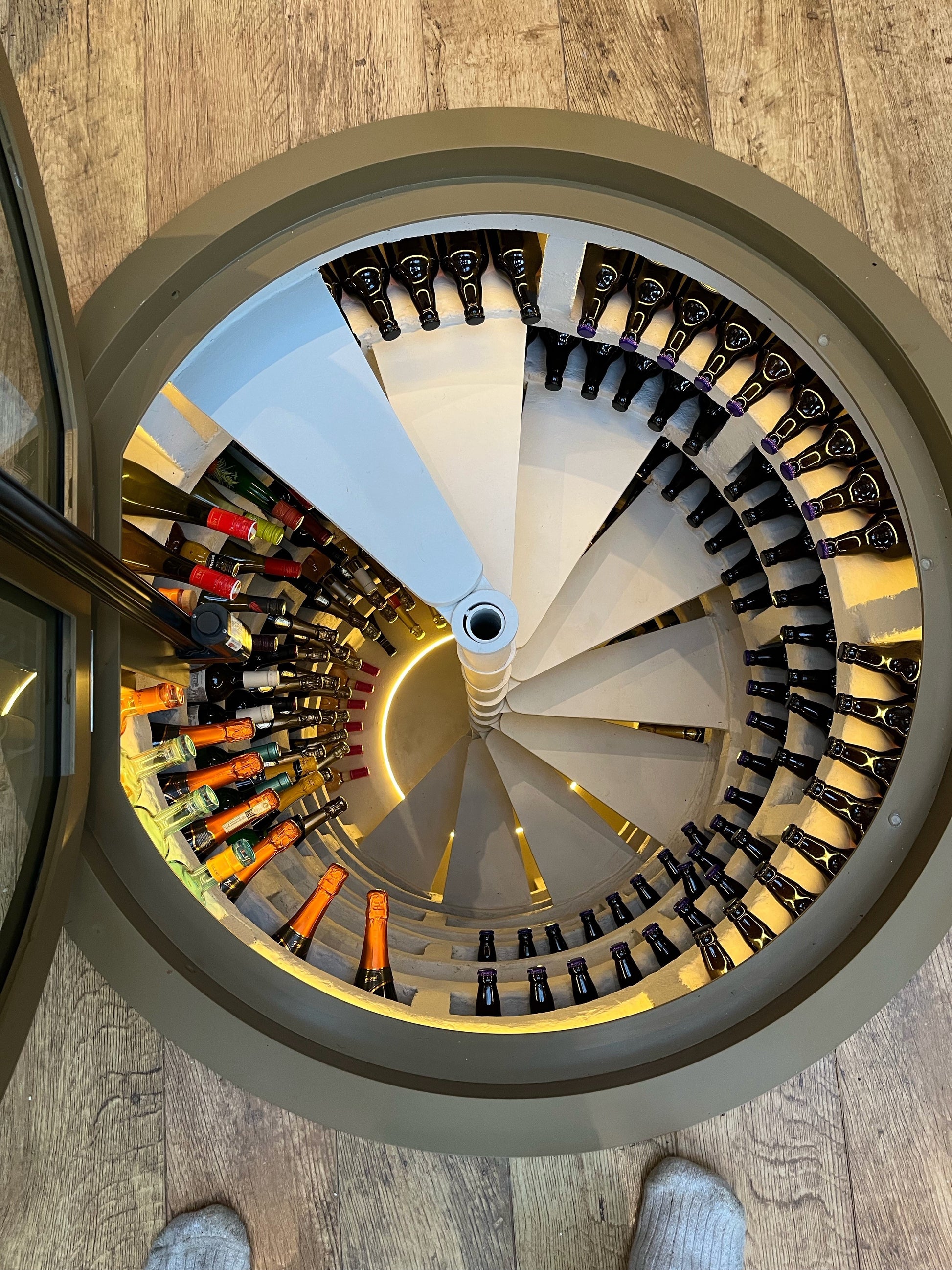 Spiral wine cellar glass lid hatch. Entrance to underground storage vault.