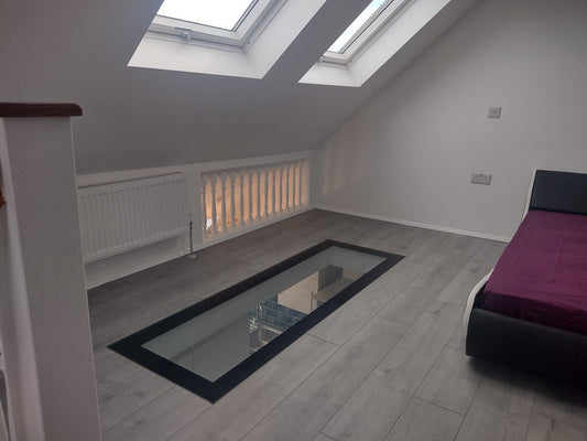 walk on glass floor panel with painted border in loft conversion