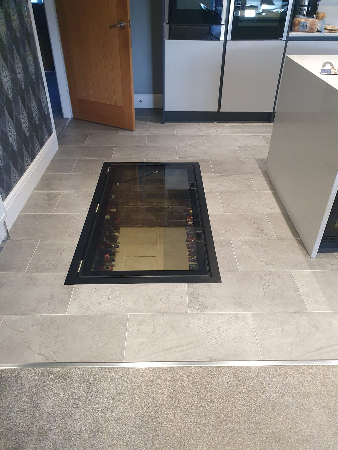 Hinged Glass Wine Cellar Doors as a Kitchen Feature