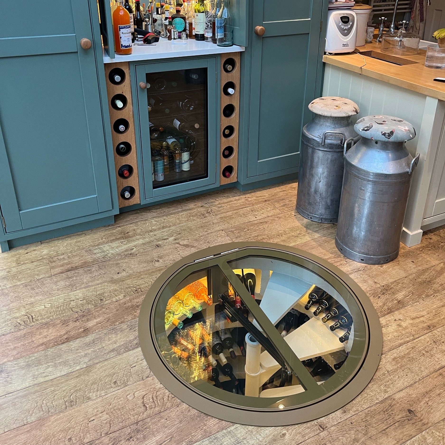 kitchen with underground spiral wine cellar glass door